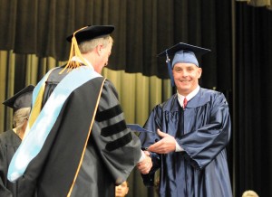 Brian Burgess (right) of Harnett County, receives his General Educational Development diploma from Central Carolina Community College President Dr. Bud Marchant during the college’s Adult High School/GED graduation Jan. 16 in the Dennis A. Wicker Civic Center.